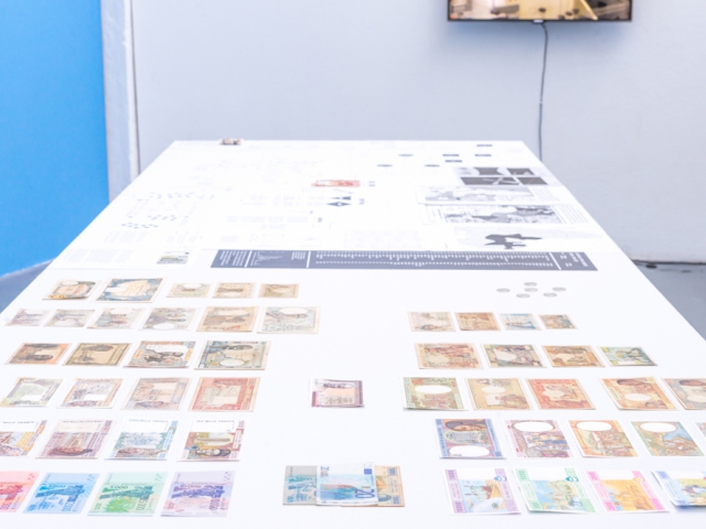 Nucleus of Capital, installation view, compilation of archival documents, photo Floris de Vries, 2021 and case studies, different formats of prints, collection of artist's 60 original CFA banknotes and coins from 1945–2020, 